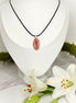 collier noir et  rhodochrosite