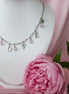 Collier LovE ou AMOUR en acier inoxydable et quartz rose